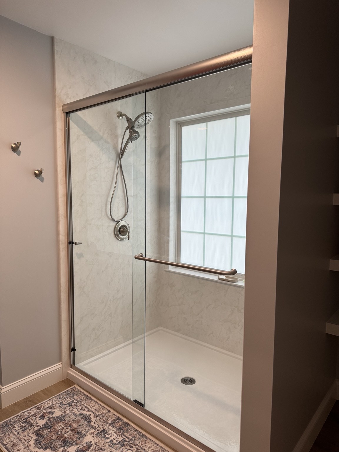 New walk-in shower with glass doors in the former bathtub space