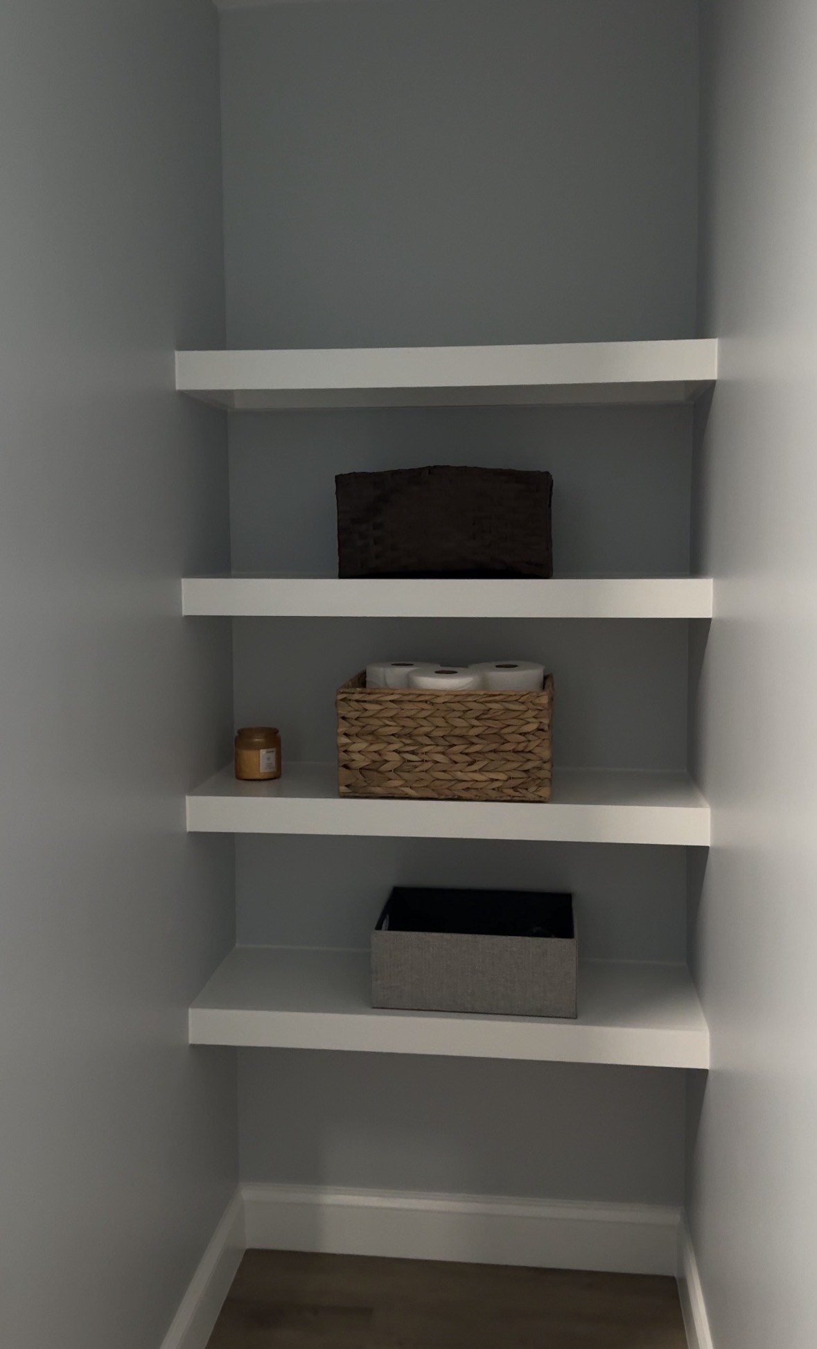 Built-in storage shelves in the former shower space